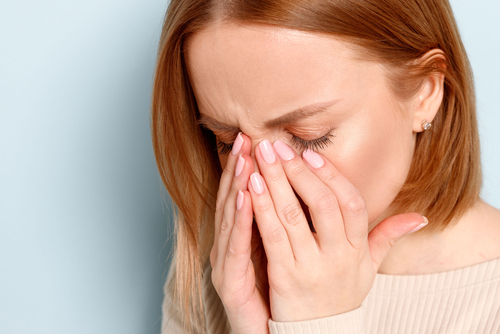 Woman rubbing her eyes