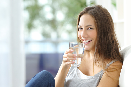 woman holding glass of water