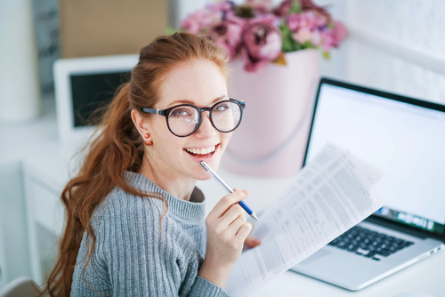 LASIK Livingston Young woman with glasses researching LASIK