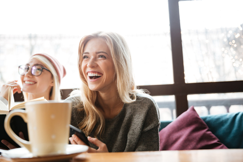 Young Women Laughing with Coffee